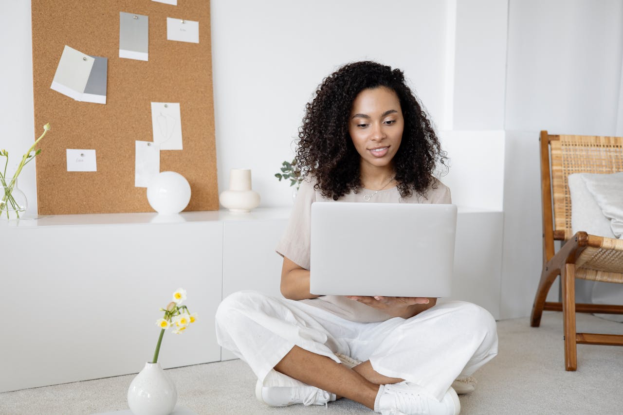 Services Woman In White Dress Shirt And White Pants Sitting On Floor Using Macbook 7552374